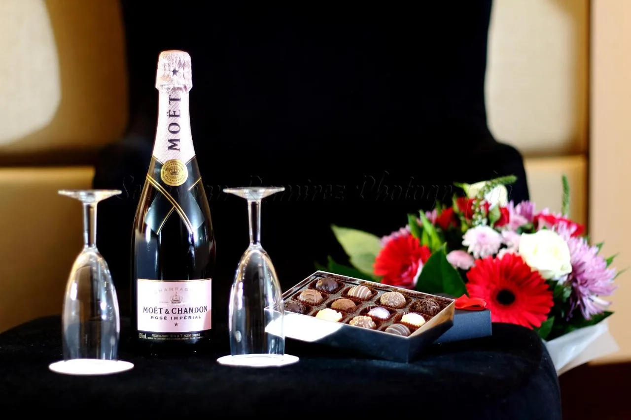 A bottle of champagne and a box of chocolates and flowers at Montcalm Piccadilly Townhouse, London West End