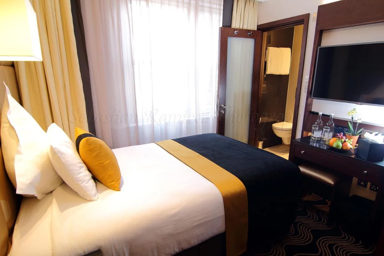 A hotel room with a bed and a television at Montcalm Piccadilly Townhouse, London West End