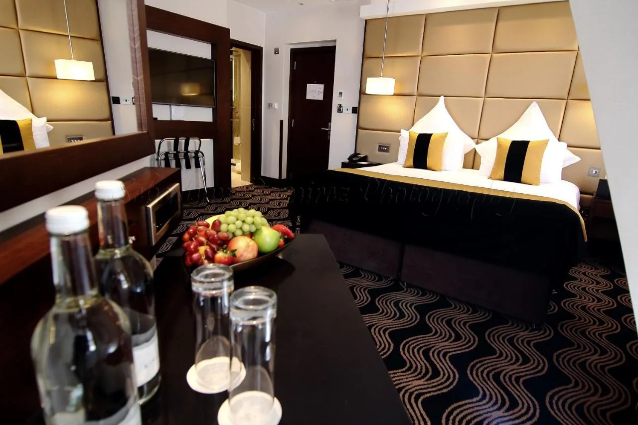 A hotel room with a table and a bowl of fruit at Montcalm Piccadilly Townhouse, London West End
