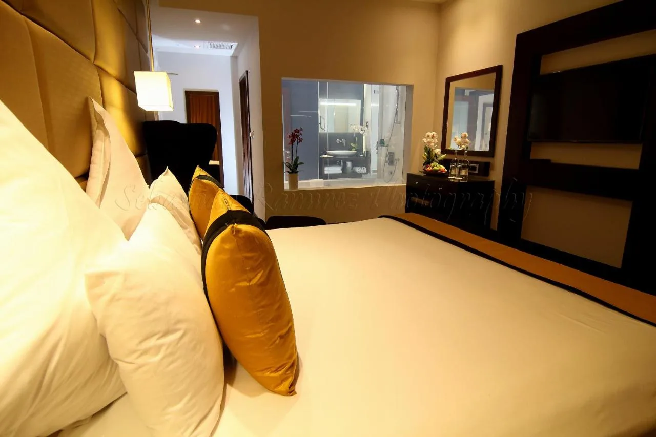 A hotel room with a large bed with pillows at Montcalm Piccadilly Townhouse, London West End