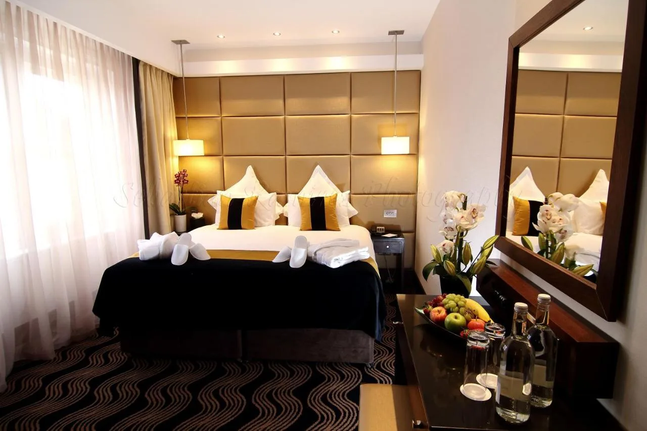 A hotel room with a bed and a mirror at Montcalm Piccadilly Townhouse, London West End