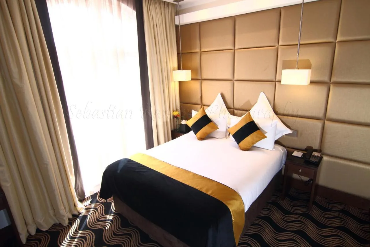 A hotel room with a bed by a window at Montcalm Piccadilly Townhouse, London West End