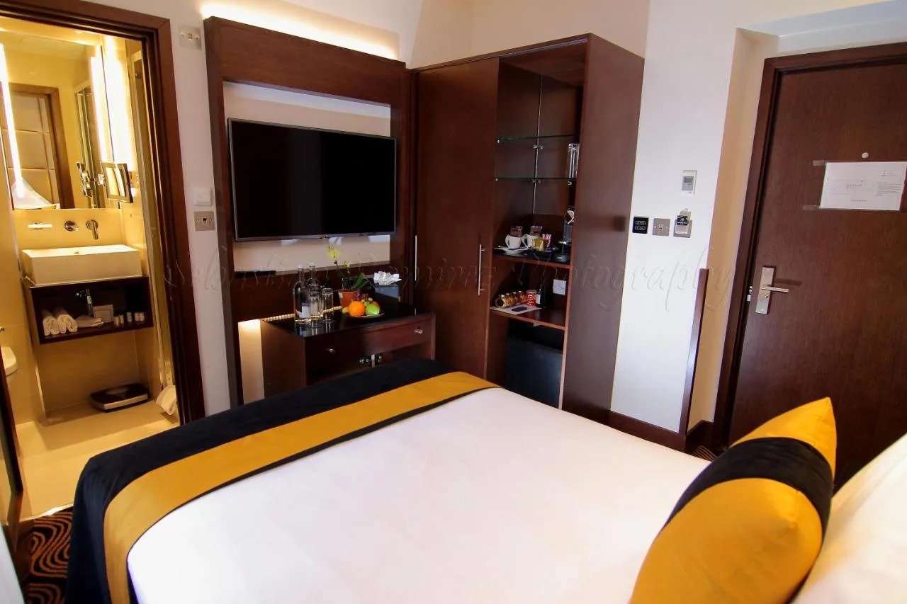 A bedroom with a large bed and a television at Montcalm Piccadilly Townhouse, London West End